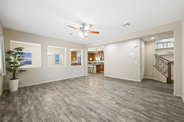 6713 Guidestar St, North Las Vegas, NV 89084 - unfurnished living room with wood finished floors, a ceiling fan, stairway, and recessed lighting