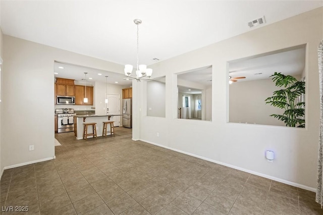 6713 Guidestar St, North Las Vegas, NV 89084 - unfurnished living room with a chandelier, ceiling fan, recessed lighting, and tile patterned floors
