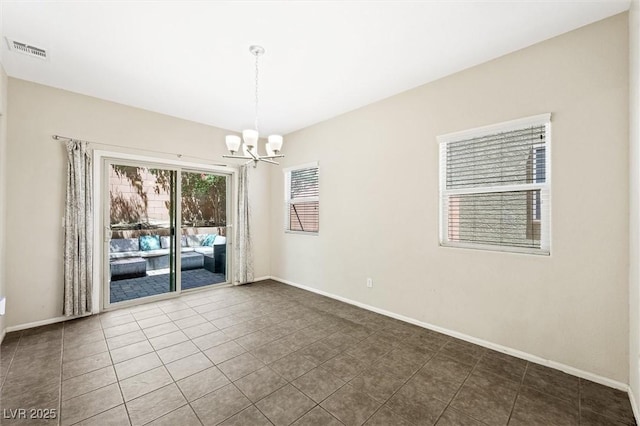 6713 Guidestar St, North Las Vegas, NV 89084 - tiled spare room featuring a chandelier and baseboards