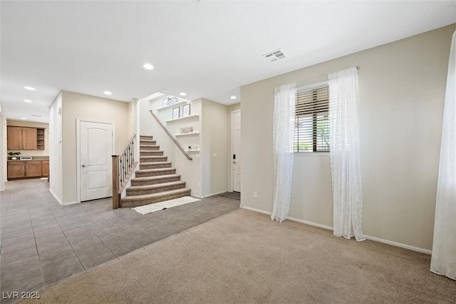 6713 Guidestar St, North Las Vegas, NV 89084 - empty room featuring stairway, recessed lighting, light carpet, and light tile patterned floors