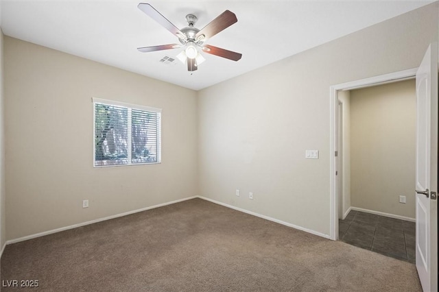 6713 Guidestar St, North Las Vegas, NV 89084 - unfurnished room featuring dark carpet, a ceiling fan, and dark tile patterned flooring