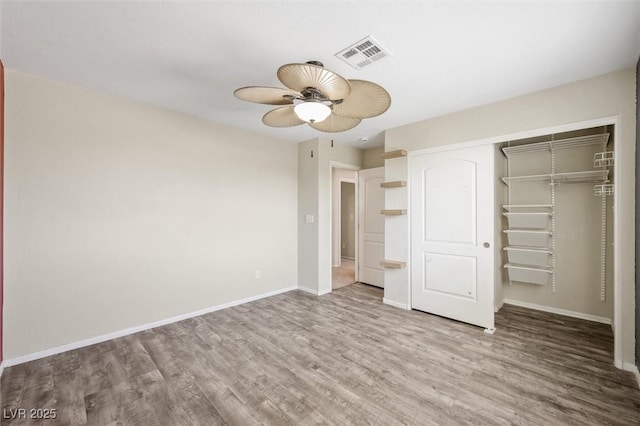 6713 Guidestar St, North Las Vegas, NV 89084 - unfurnished bedroom with wood finished floors, a closet, and a ceiling fan