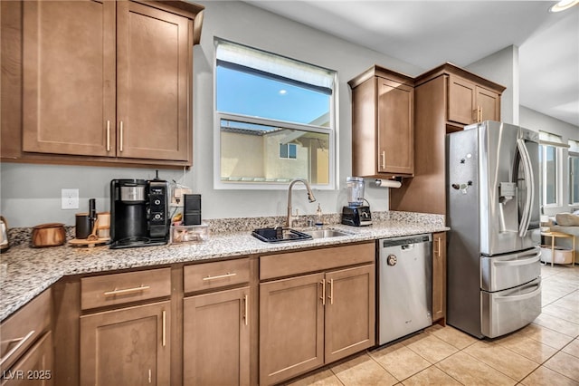 2024 Mystic Wave Rd, North Las Vegas, NV 89031 - kitchen featuring stainless steel appliances, light tile patterned flooring, light stone counters, and brown cabinets