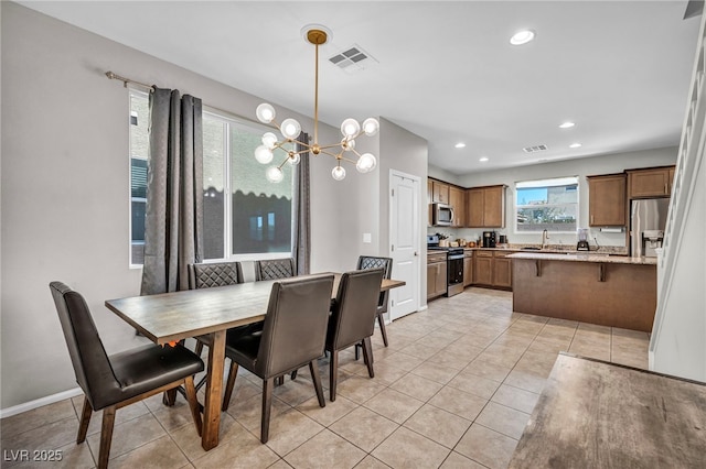 2024 Mystic Wave Rd, North Las Vegas, NV 89031 - dining room with a chandelier, light tile patterned floors, and recessed lighting