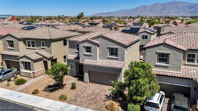 2024 Mystic Wave Rd, North Las Vegas, NV 89031 - view of front of house with a residential view, stucco siding, an attached garage, driveway, and a mountain view