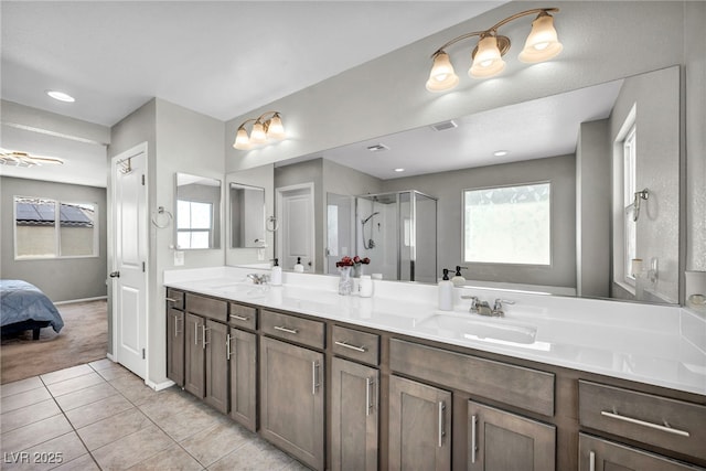 2024 Mystic Wave Rd, North Las Vegas, NV 89031 - ensuite bathroom featuring double vanity, a shower stall, tile patterned floors, and healthy amount of natural light