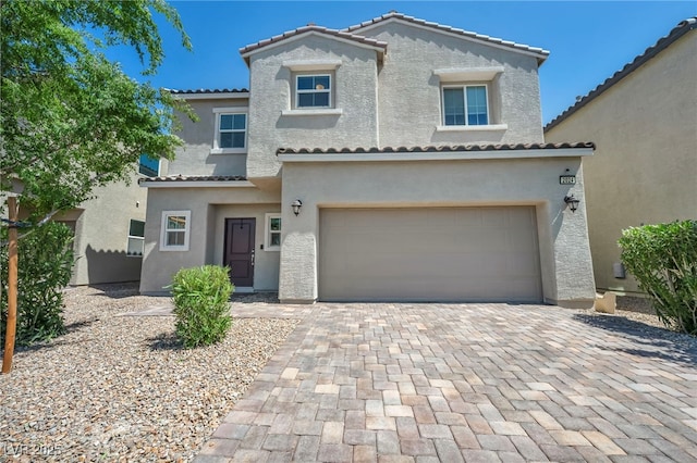 2024 Mystic Wave Rd, North Las Vegas, NV 89031 - view of front of home with a tile roof, stucco siding, an attached garage, and driveway