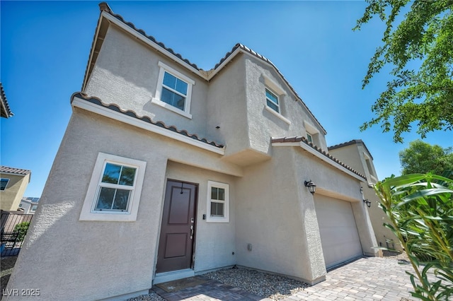 2024 Mystic Wave Rd, North Las Vegas, NV 89031 - mediterranean / spanish home with stucco siding, a tiled roof, and a garage