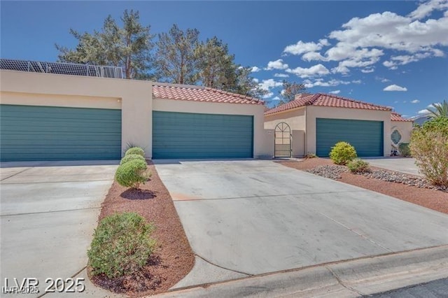 2723 Seabridge Dr, Las Vegas, NV 89121 - view of front of home with stucco siding, a tile roof, driveway, and a garage