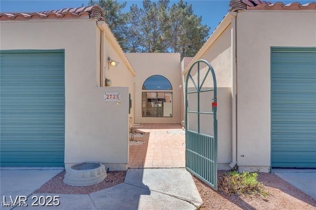 2723 Seabridge Dr, Las Vegas, NV 89121 - doorway to property featuring stucco siding, a gate, and a tile roof