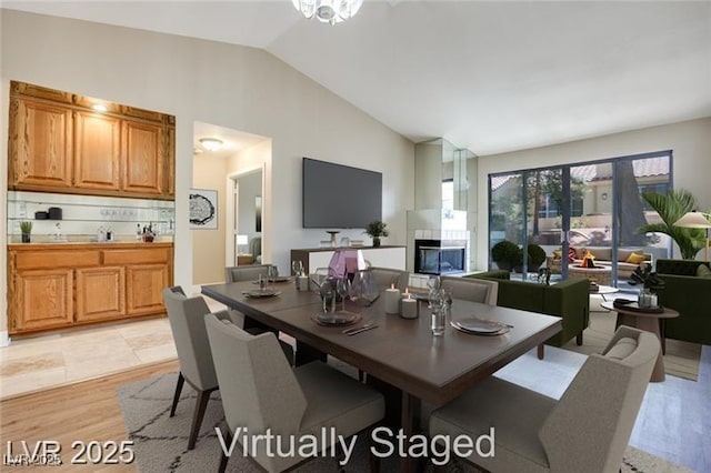 2723 Seabridge Dr, Las Vegas, NV 89121 - dining area with light wood-type flooring and high vaulted ceiling