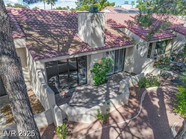 2723 Seabridge Dr, Las Vegas, NV 89121 - rear view of property with a tiled roof, stucco siding, and a patio