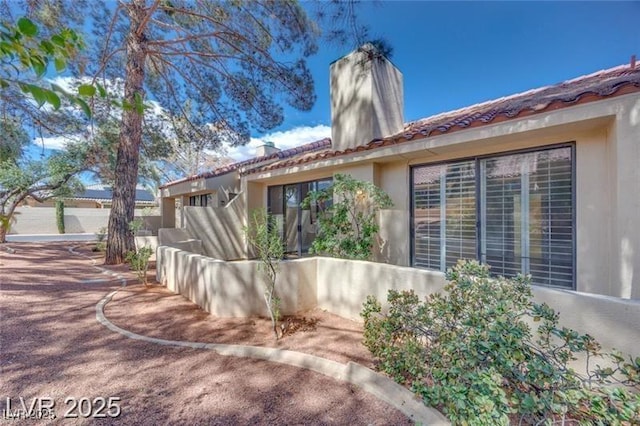 2723 Seabridge Dr, Las Vegas, NV 89121 - rear view of house with stucco siding and a chimney