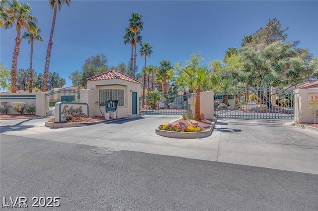 2723 Seabridge Dr, Las Vegas, NV 89121 - view of asphalt street featuring a gate, a gated entry, and curbs