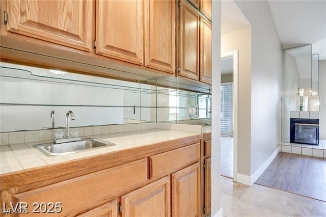 2723 Seabridge Dr, Las Vegas, NV 89121 - kitchen with tile counters, a tiled fireplace, and light tile patterned flooring