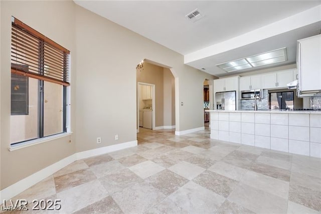 2723 Seabridge Dr, Las Vegas, NV 89121 - unfurnished living room with arched walkways and baseboards