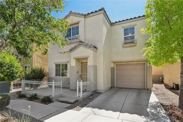 7640 Woven Memories St, Las Vegas, NV 89149 - mediterranean / spanish-style house featuring an attached garage, a tiled roof, stucco siding, and driveway