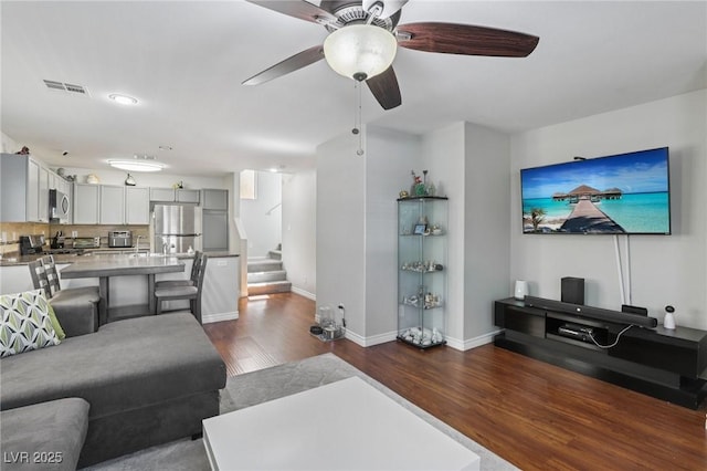 7640 Woven Memories St, Las Vegas, NV 89149 - living room with stairs, dark wood-style flooring, and ceiling fan