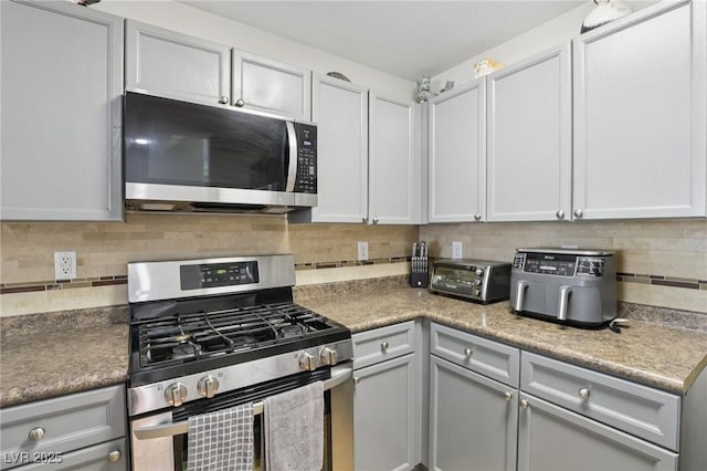 7640 Woven Memories St, Las Vegas, NV 89149 - kitchen with appliances with stainless steel finishes, backsplash, and gray cabinetry