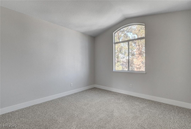 2212 Warm Walnut Dr, Las Vegas, NV 89134 - empty room with light colored carpet and vaulted ceiling