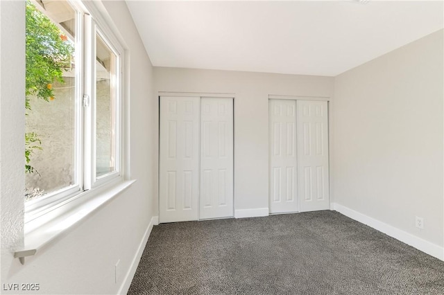 811 Spyglass Ln, Las Vegas, NV 89107 - unfurnished bedroom with multiple closets and dark carpet
