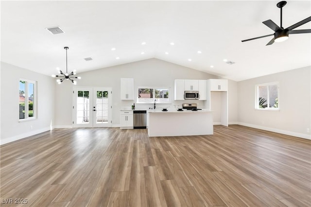 811 Spyglass Ln, Las Vegas, NV 89107 - unfurnished living room with high vaulted ceiling, a chandelier, light wood-style floors, healthy amount of natural light, and recessed lighting