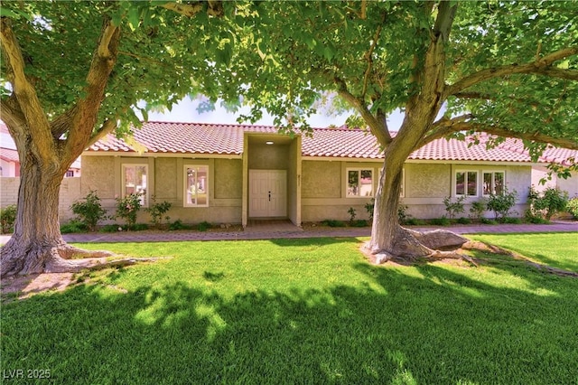 811 Spyglass Ln, Las Vegas, NV 89107 - ranch-style home featuring a tiled roof, stucco siding, and a front lawn