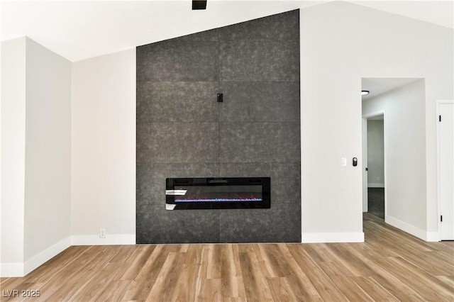 811 Spyglass Ln, Las Vegas, NV 89107 - unfurnished living room with wood finished floors and a fireplace