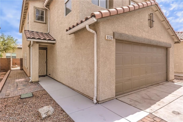 9129 Patrick Henry Ave, Las Vegas, NV 89149 - view of property exterior featuring a tiled roof, stucco siding, and a garage