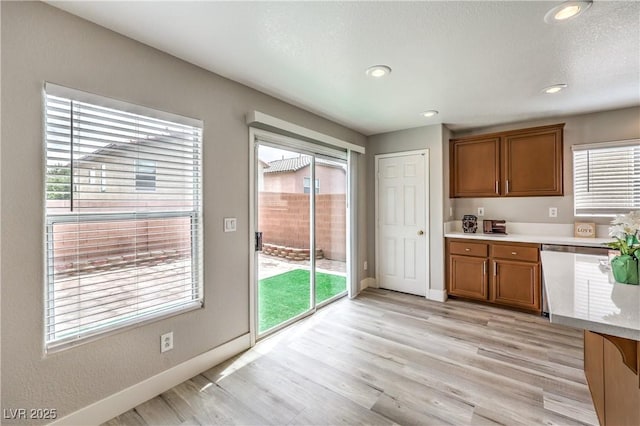 9129 Patrick Henry Ave, Las Vegas, NV 89149 - kitchen with brown cabinetry, light countertops, light wood-style flooring, and recessed lighting