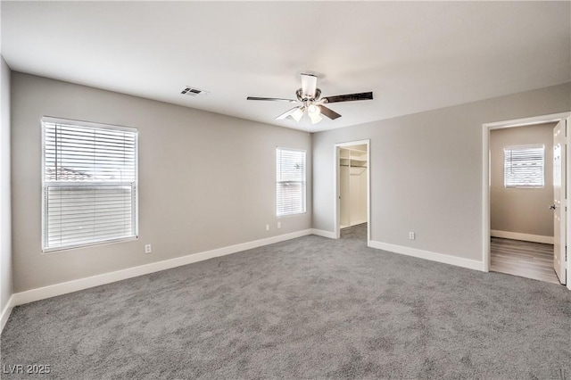 9129 Patrick Henry Ave, Las Vegas, NV 89149 - unfurnished bedroom with carpet, a spacious closet, a ceiling fan, and a closet