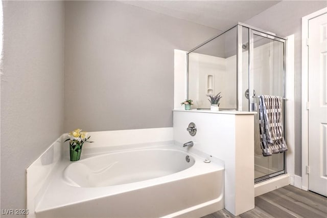 9129 Patrick Henry Ave, Las Vegas, NV 89149 - bathroom featuring a garden tub, a stall shower, and wood finished floors