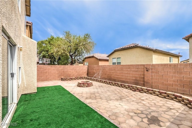 9129 Patrick Henry Ave, Las Vegas, NV 89149 - fenced backyard with a patio and a fire pit