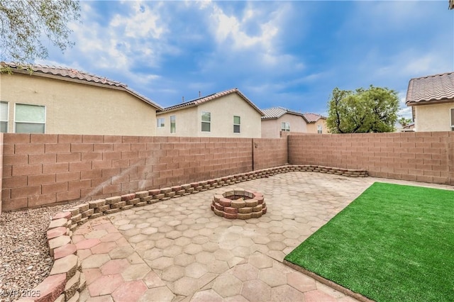 9129 Patrick Henry Ave, Las Vegas, NV 89149 - fenced backyard with a fire pit and a patio area