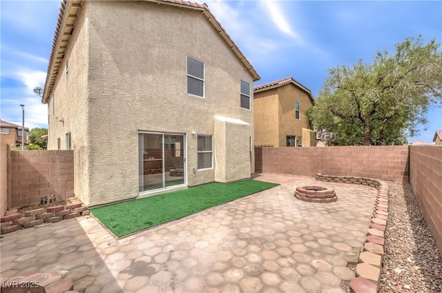 9129 Patrick Henry Ave, Las Vegas, NV 89149 - back of house featuring a fire pit, a patio area, stucco siding, and a fenced backyard