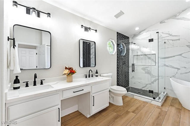 8113 Bay Springs Dr, Las Vegas, NV 89128 - full bathroom with a marble finish shower, double vanity, wood finished floors, a freestanding tub, and recessed lighting