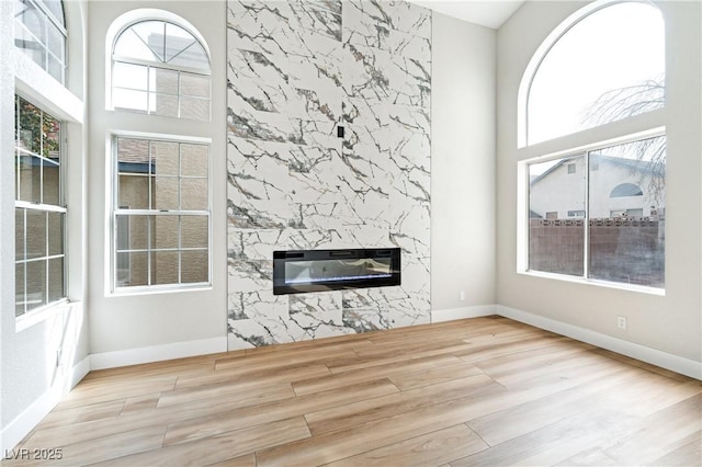 8113 Bay Springs Dr, Las Vegas, NV 89128 - unfurnished living room with wood finished floors, plenty of natural light, and a high end fireplace