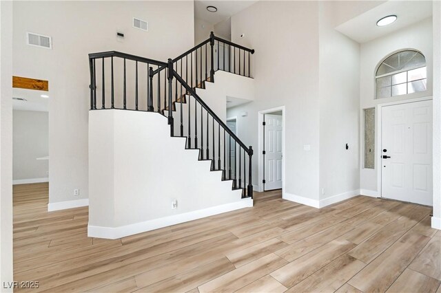 8113 Bay Springs Dr, Las Vegas, NV 89128 - entryway featuring a towering ceiling, stairs, and light wood-type flooring