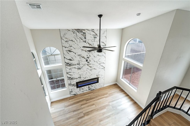 8113 Bay Springs Dr, Las Vegas, NV 89128 - unfurnished living room featuring healthy amount of natural light, wood finished floors, ceiling fan, and a high end fireplace