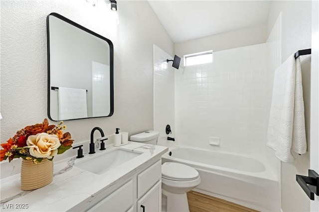 8113 Bay Springs Dr, Las Vegas, NV 89128 - bathroom featuring vanity, bathtub / shower combination, wood finished floors, and a textured wall