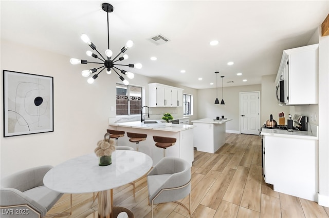 8113 Bay Springs Dr, Las Vegas, NV 89128 - dining area with a chandelier, light wood-style floors, and recessed lighting