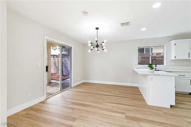8113 Bay Springs Dr, Las Vegas, NV 89128 - unfurnished dining area featuring a chandelier, light wood-type flooring, and recessed lighting