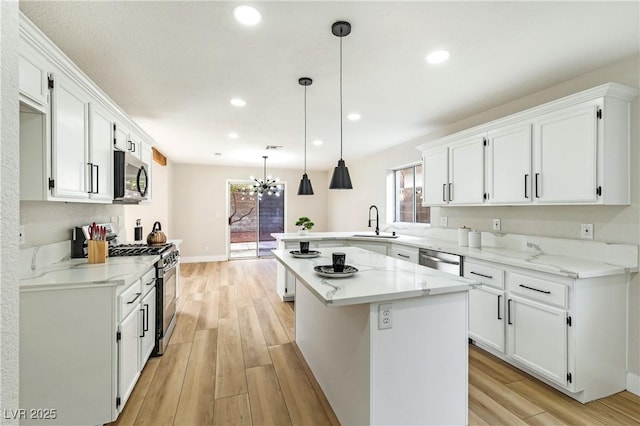 8113 Bay Springs Dr, Las Vegas, NV 89128 - kitchen featuring stainless steel appliances, light wood-style floors, white cabinetry, a peninsula, and recessed lighting
