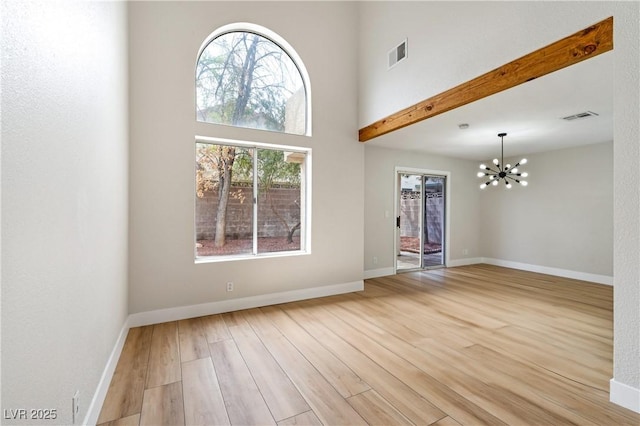 8113 Bay Springs Dr, Las Vegas, NV 89128 - unfurnished room featuring wood finished floors, a chandelier, and a towering ceiling