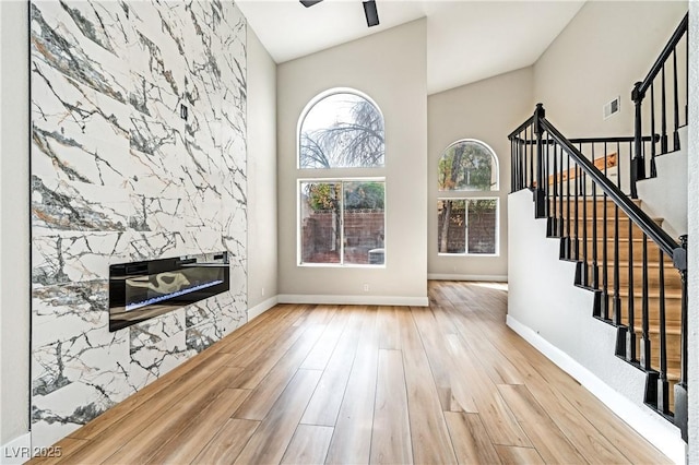 8113 Bay Springs Dr, Las Vegas, NV 89128 - unfurnished living room featuring wood finished floors, stairs, and a towering ceiling