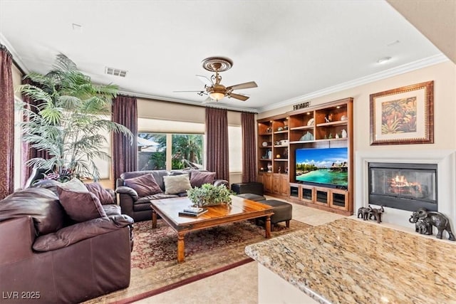 8623 Kennedy Heights Ct, Las Vegas, NV 89131 - living area featuring crown molding, a ceiling fan, and a fireplace with flush hearth