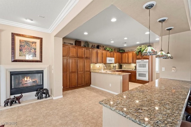 8623 Kennedy Heights Ct, Las Vegas, NV 89131 - kitchen with white appliances, a peninsula, brown cabinetry, light stone counters, and recessed lighting