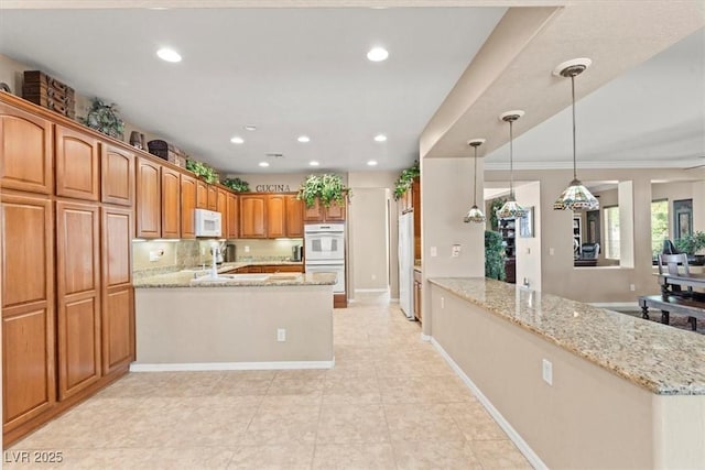 8623 Kennedy Heights Ct, Las Vegas, NV 89131 - kitchen with a peninsula, white appliances, recessed lighting, light stone counters, and light tile patterned flooring