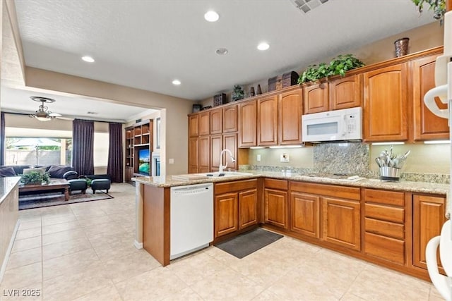 8623 Kennedy Heights Ct, Las Vegas, NV 89131 - kitchen featuring white appliances, a peninsula, open floor plan, brown cabinetry, and recessed lighting