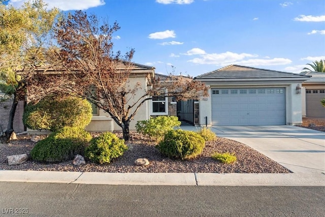 8623 Kennedy Heights Ct, Las Vegas, NV 89131 - view of front of home featuring stucco siding, an attached garage, and concrete driveway